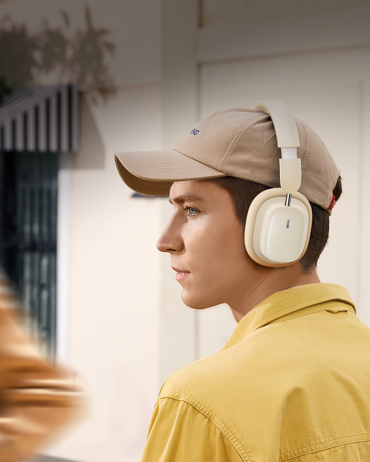A young man wears Baseus Headphone and listens music 